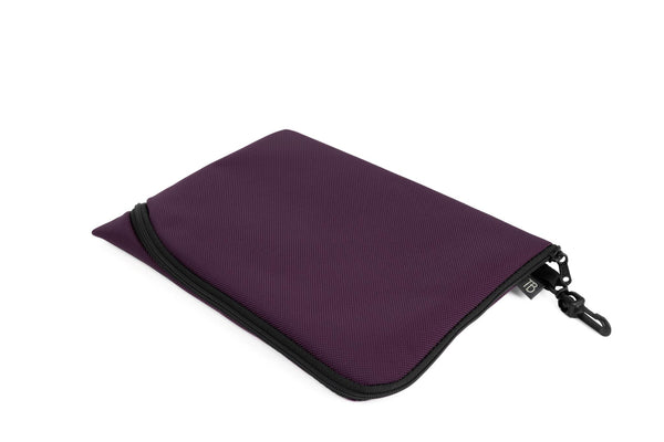 An A5 Ghost Whale Pouch in Aubergine (dark purple).